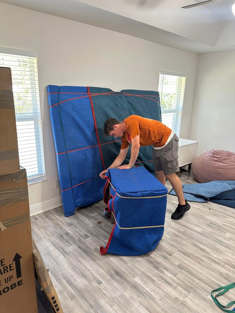 A Central Florida Pros mover padding and wrapping furniture